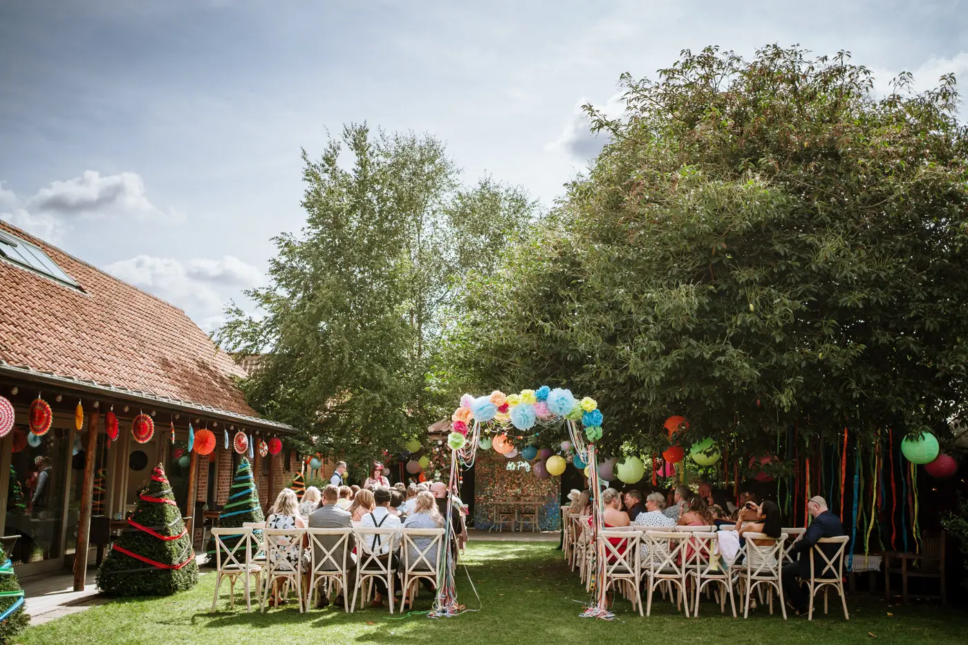 The view down the coach house aisle at Doddington Hall, Lincolnshire beautifully set up for Amy and Abby's wedding ceremony