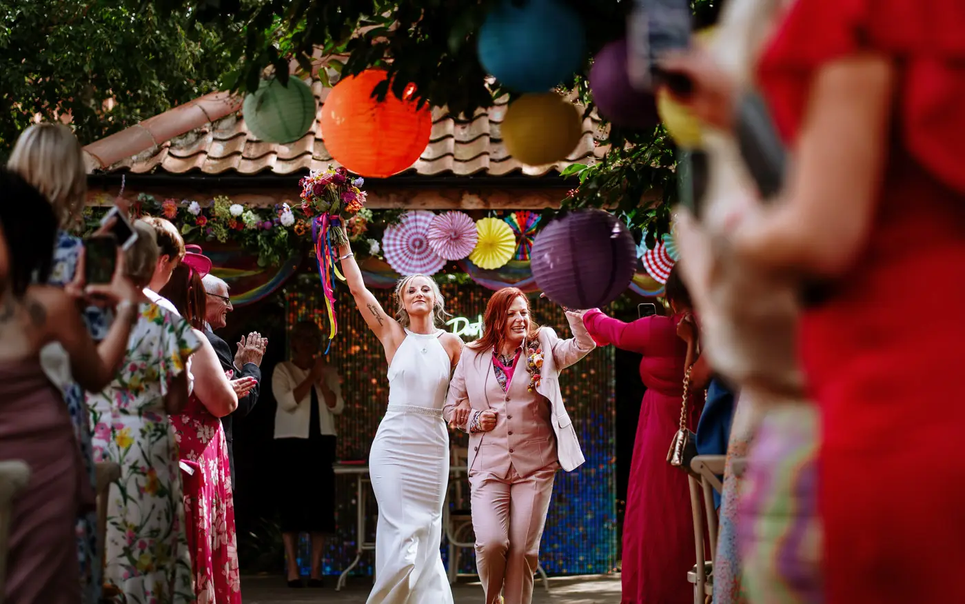 Amy and Abby starting their recessional walk as a married couple at Doddington Hall, Lincolnshire, documentary wedding photography by Gary Phillip