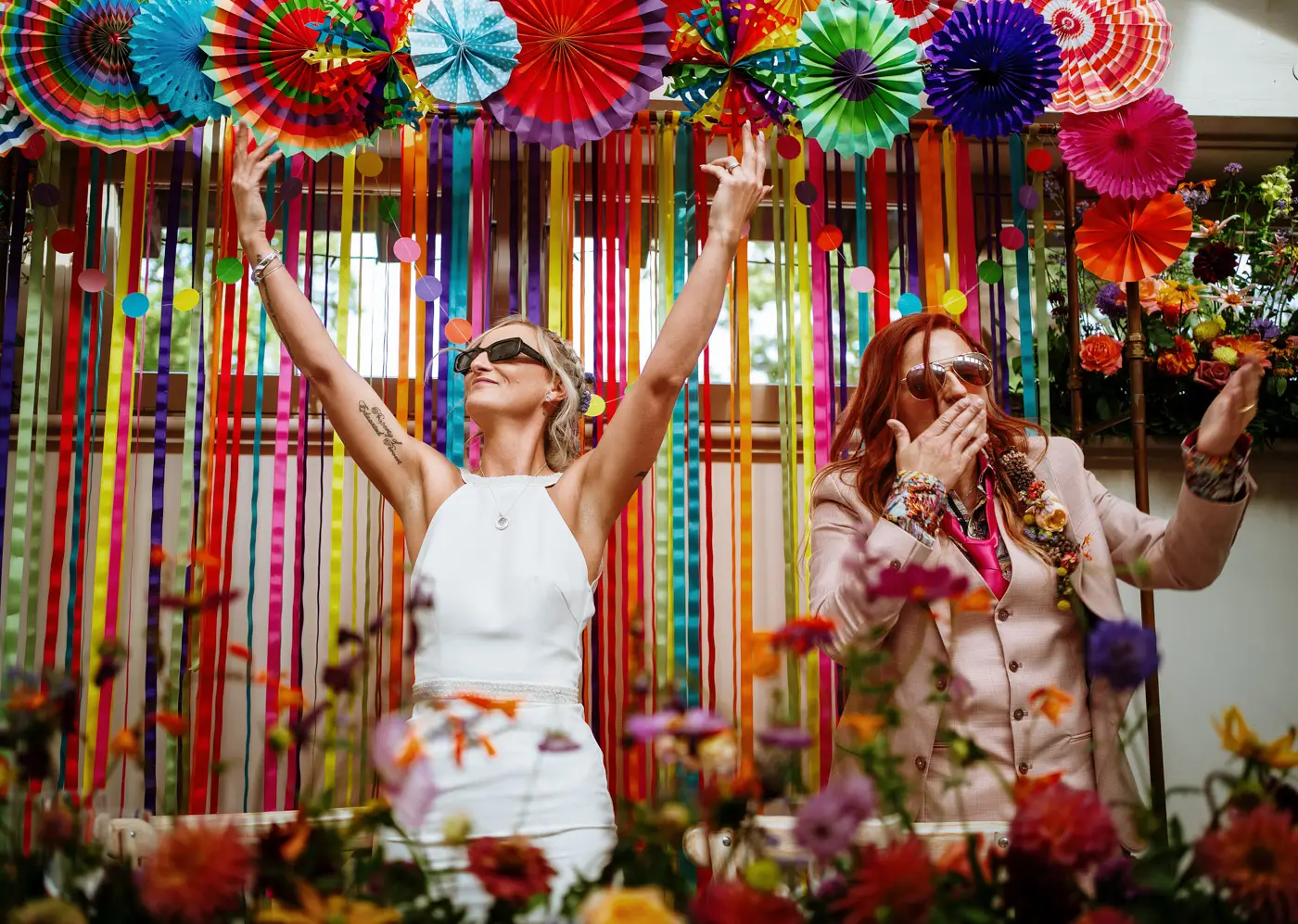 Amy and Abby arriving at their table blowing kisses with arms raised to take the applause for their entrance at Doddington Hall, Lincolnshire
