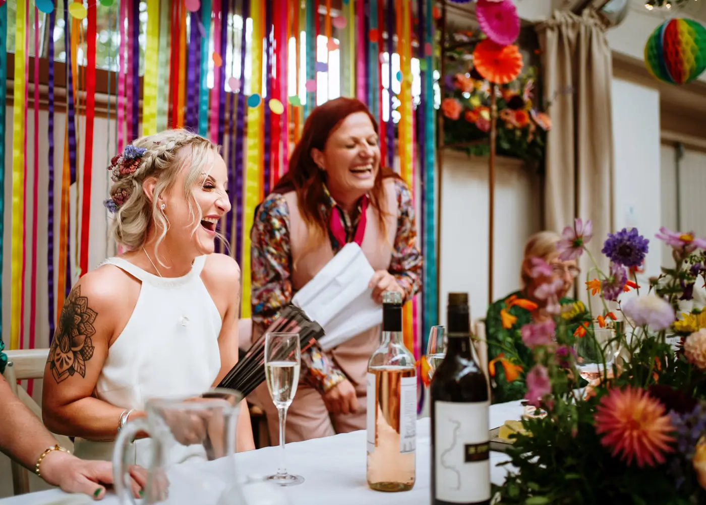 Amy and Abby laughing together during the wedding speeches at Doddington Hall, Lincolnshire