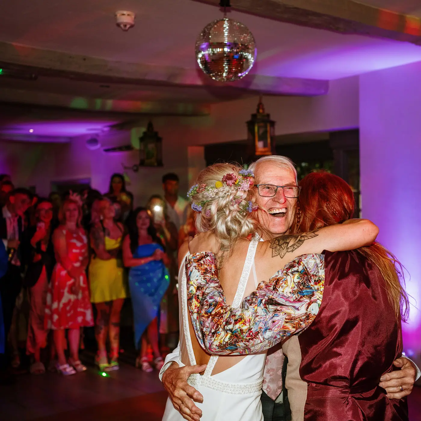 Dad getting involved on the dancefloor with hugs all round from Amy and Abby at Doddington Hall, Lincolnshire