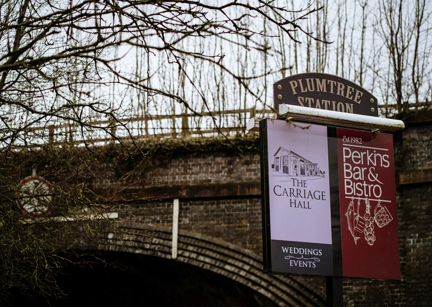 The Carriage Hall and Perkins Bar and Bistro sign with the railway bridge in the background, Nottinghamshire wedding venue
