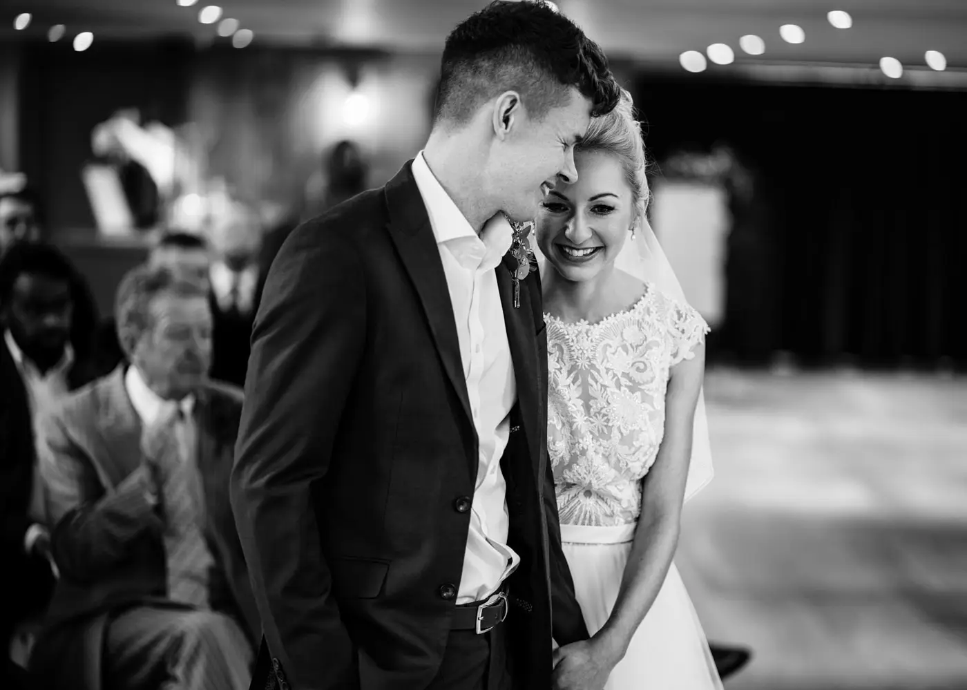 Bride Ellen and groom Ben sharing a cuddle during their wedding ceremony at Carriage Hall, Nottinghamshire