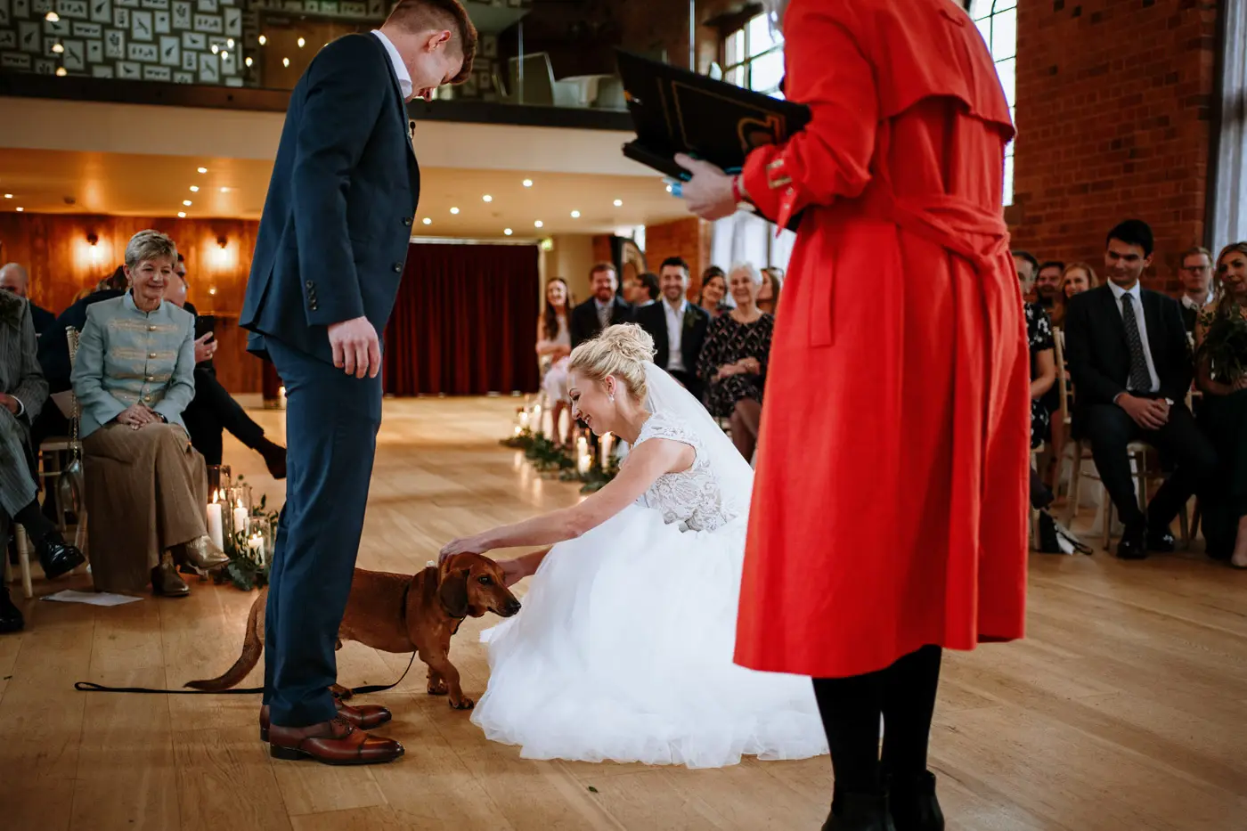 The sausage dog ring bearer bringing the rings to Ellen and Ben during their wedding ceremony at Carriage Hall, Nottinghamshire