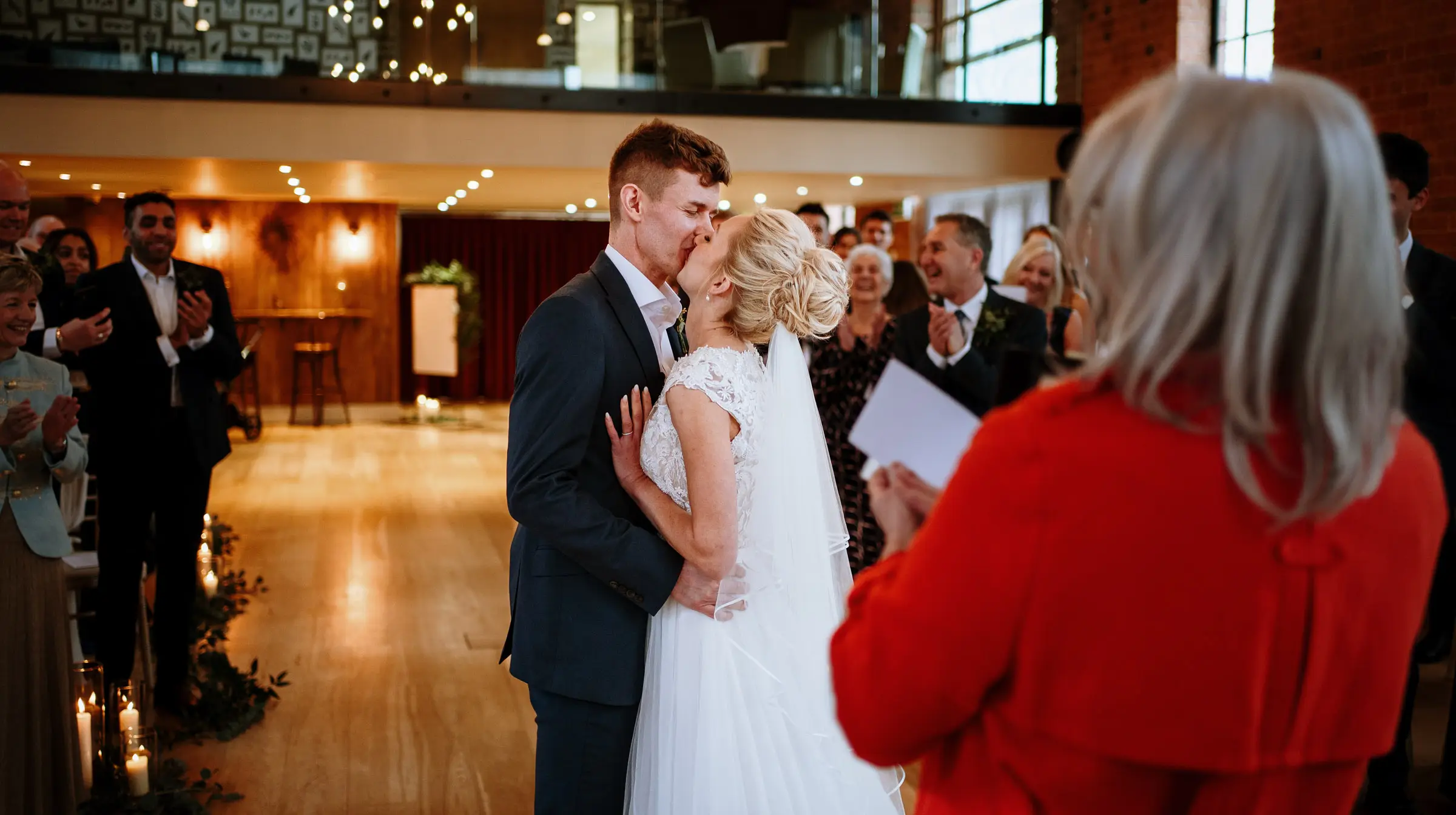 The first kiss. Ellen and Ben kiss for the first time as a married couple at Carriage Hall, Nottinghamshire, photographed by Gary Phillip