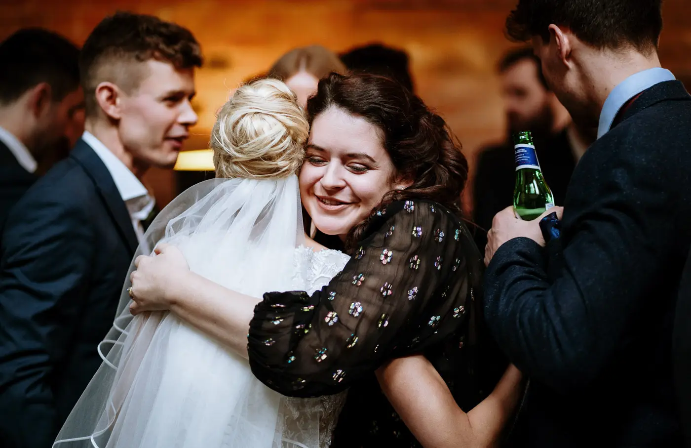 A guest hugging bride Ellen warmly after the ceremony at Carriage Hall, the joy on Ellen's face showing how much it means