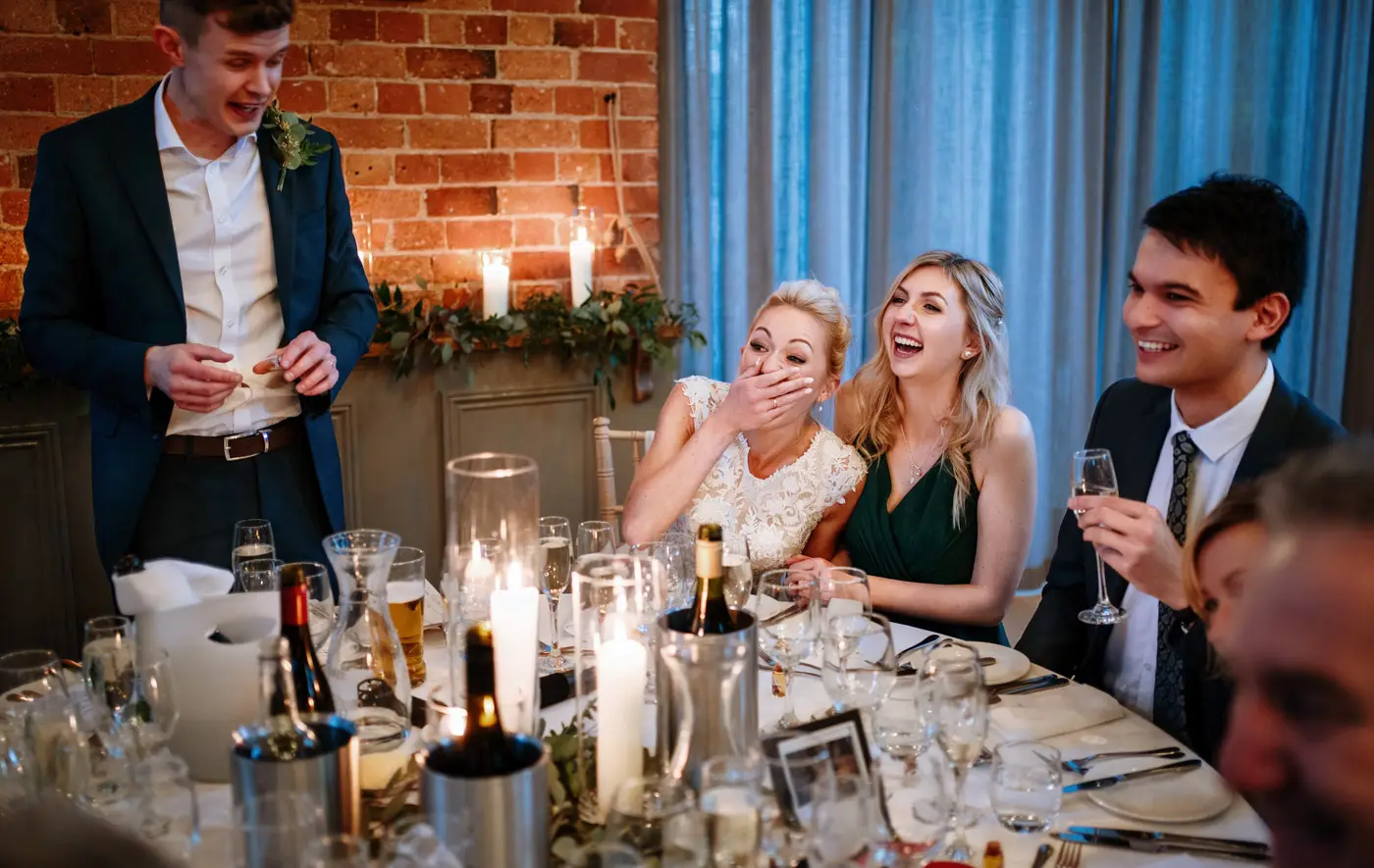 More laughs at the top table for bride Ellen and her family during the wedding speeches at Carriage Hall, Nottinghamshire