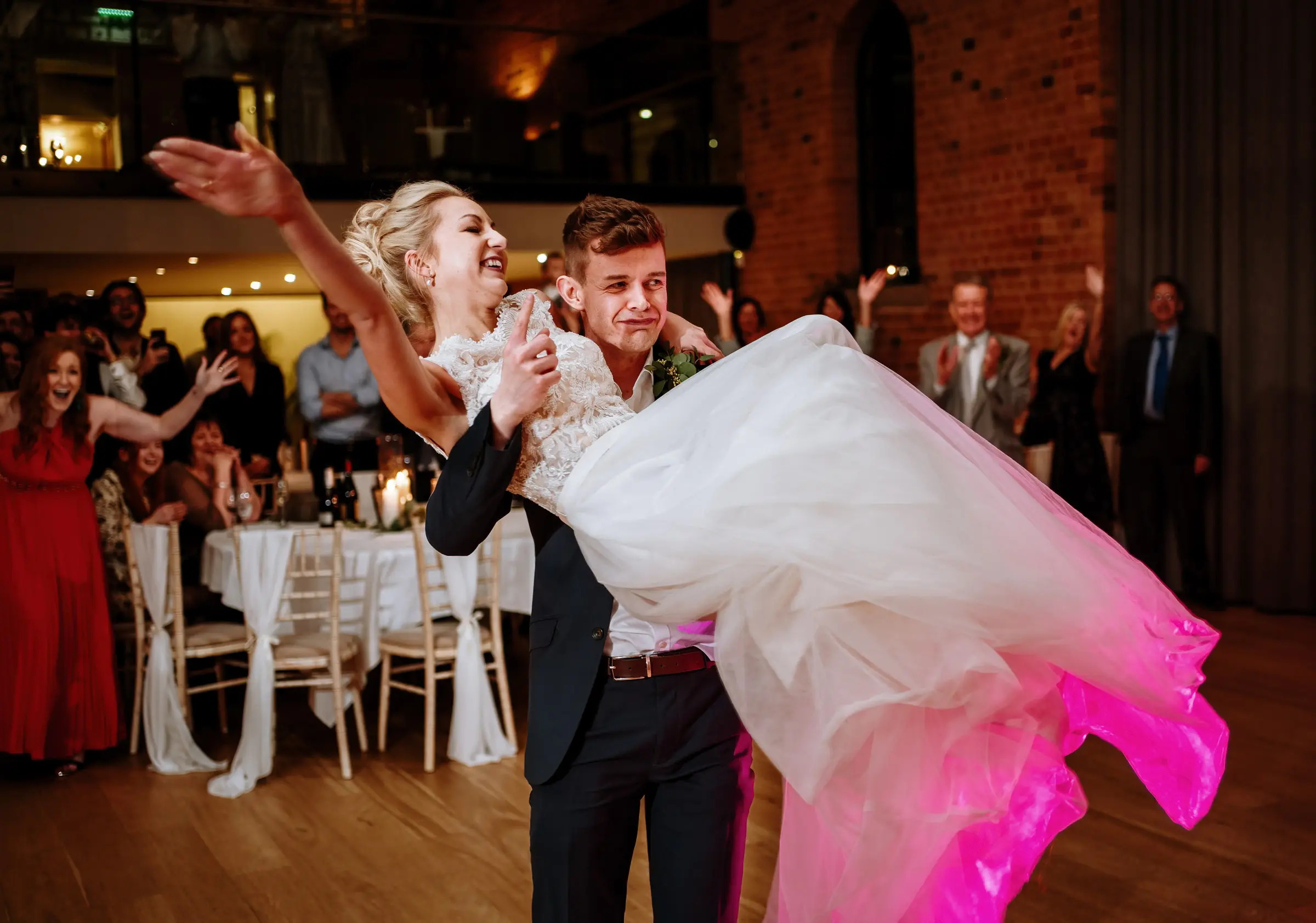 Groom Ben lifting and spinning bride Ellen around during their first dance at Carriage Hall, Nottinghamshire
