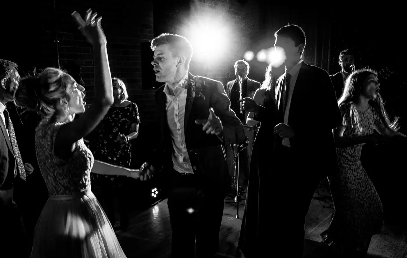 Black and white image of Ellen and Ben dancing together in the light at Carriage Hall, Nottinghamshire