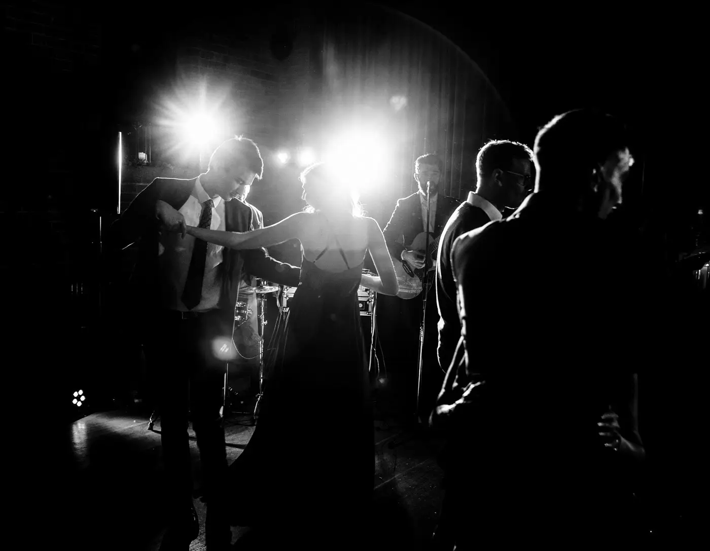 Wedding guests dancing silhouetted in the light on the dancefloor at Carriage Hall, Nottinghamshire