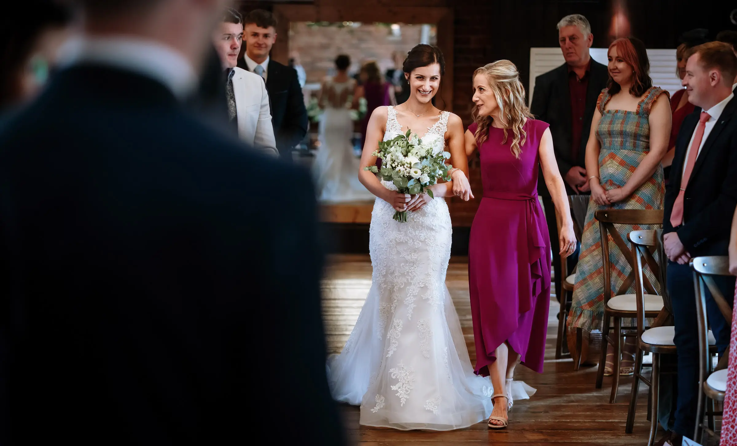 Bride Krissie walking the aisle with her mother at Swancar Farm, Nottinghamshire, an emotional ceremony moment captured by documentary photographer Gary Phillip