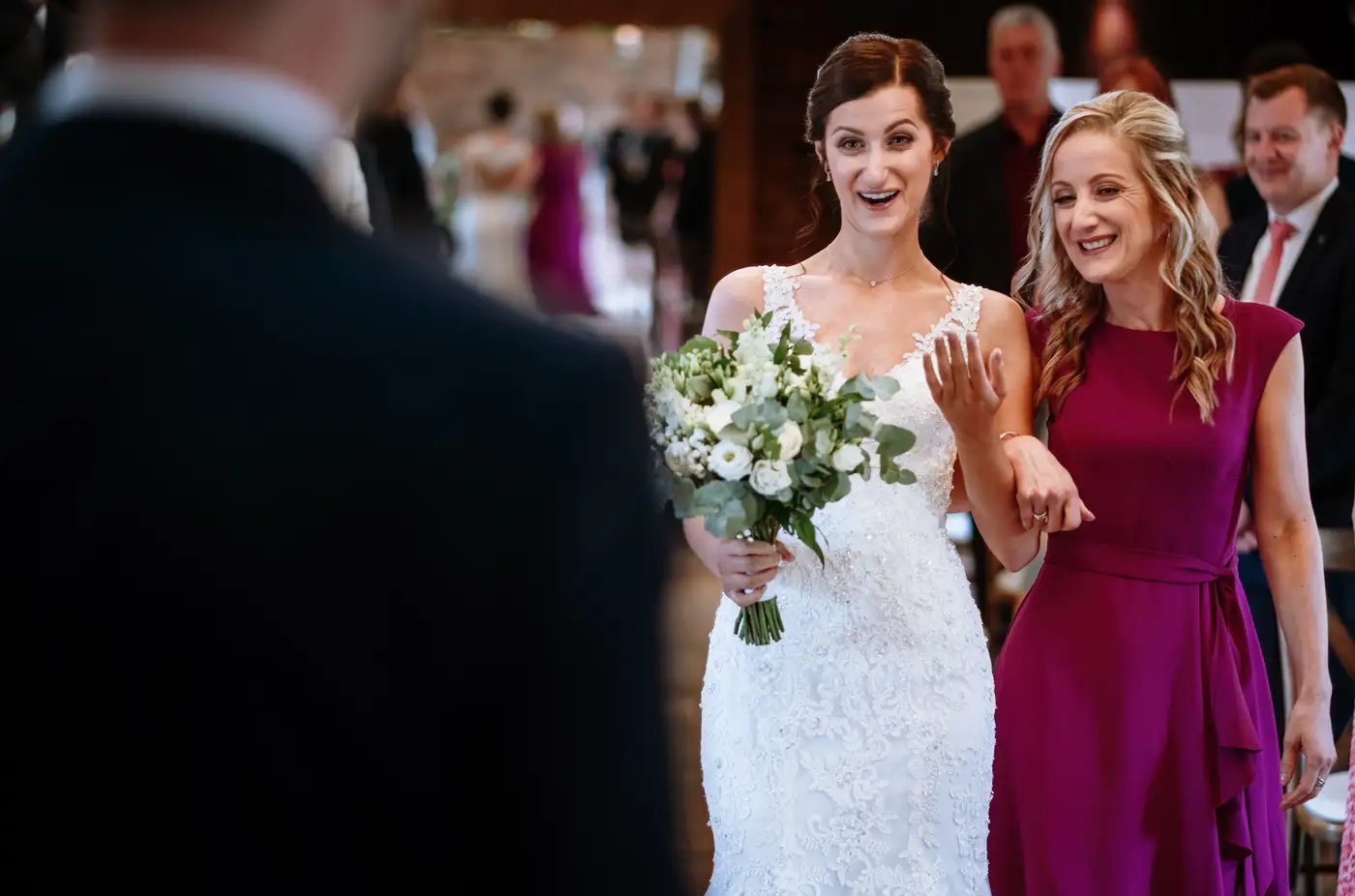 Bride Krissie surprised to see groom Tom waiting at the front of the room at Swancar Farm, a genuine unrepeatable moment from their Nottinghamshire wedding