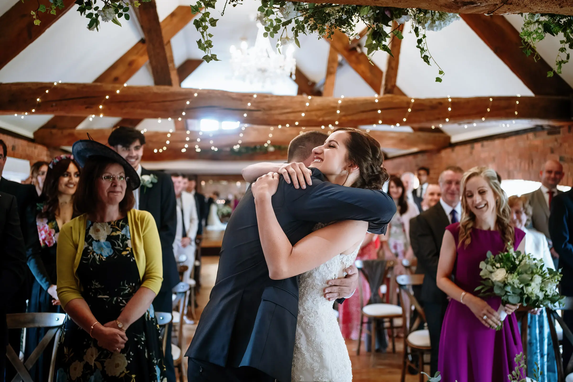 Bride Krissie and groom Tom embracing during their wedding ceremony at Swancar Farm, Nottinghamshire, documentary wedding photography by Gary Phillip