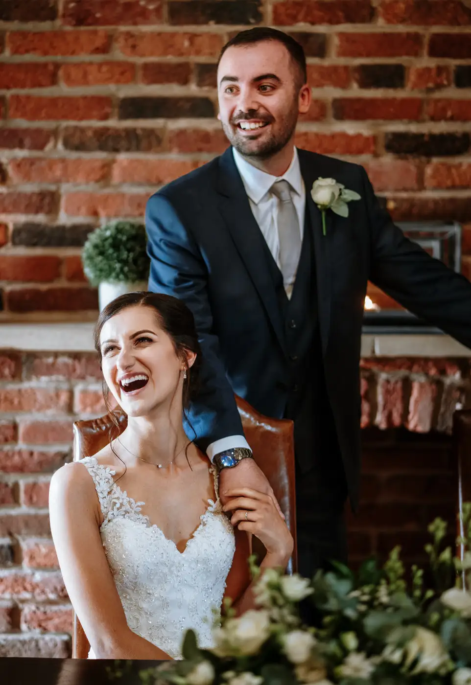 Bride Krissie and groom Tom laughing together after signing the wedding register at Swancar Farm, pure joy captured by documentary photographer Gary Phillip