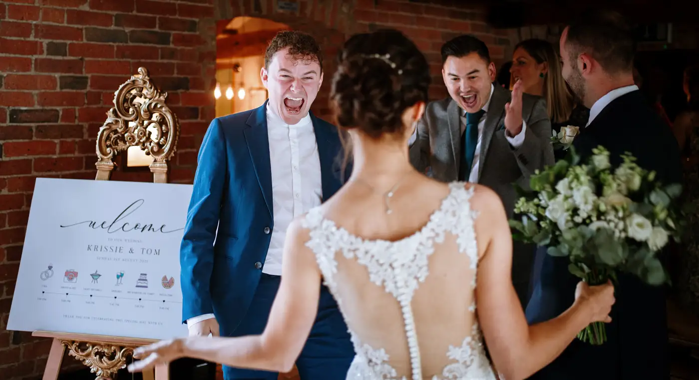 Two guests overjoyed to congratulate bride Krissie after the wedding service at Swancar Farm, one of the happiest photographs from the day by Gary Phillip