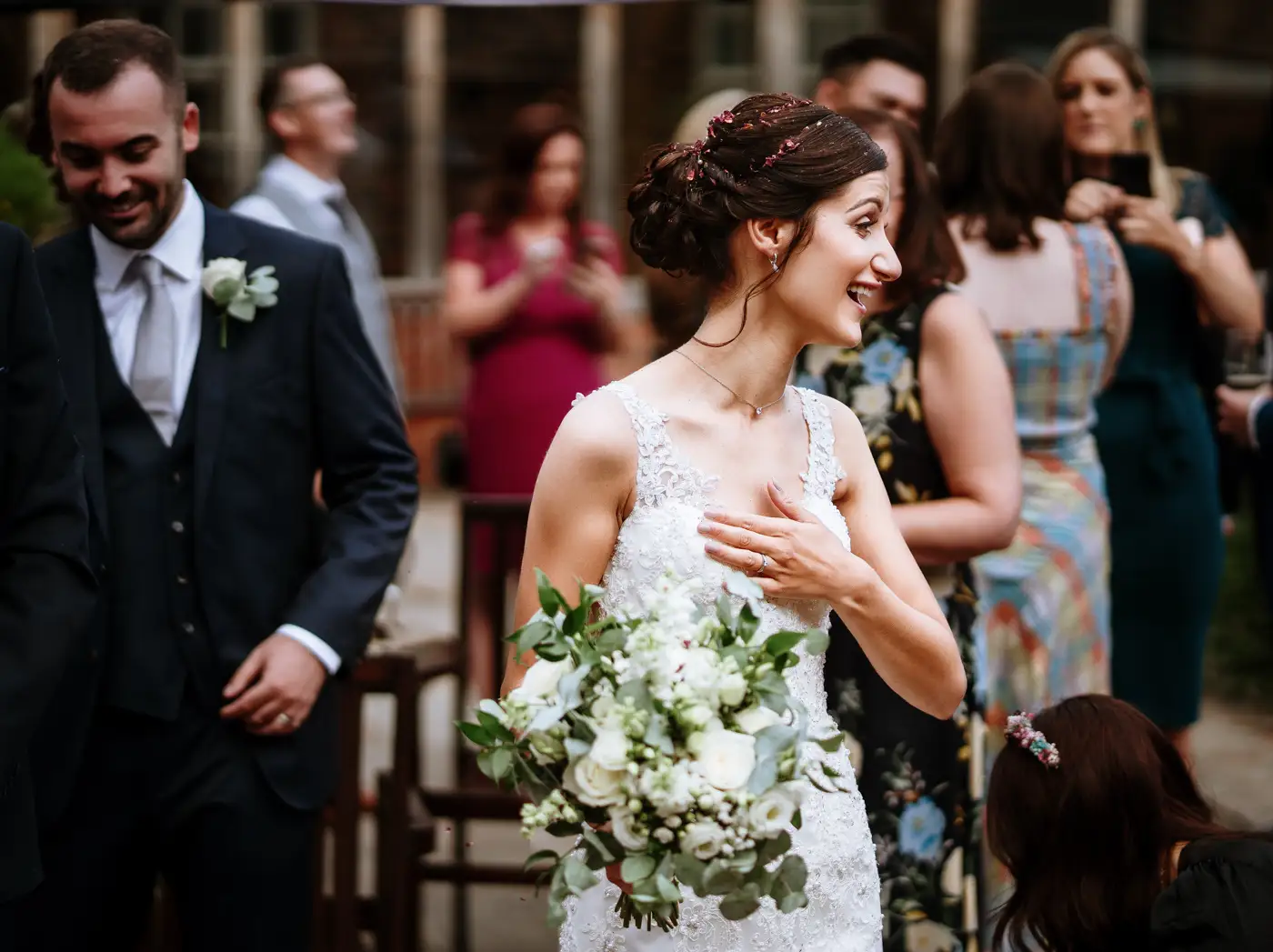 Bride Krissie with her hand on her heart thanking guests at Swancar Farm, a genuinely moving moment of gratitude captured by documentary photographer Gary Phillip