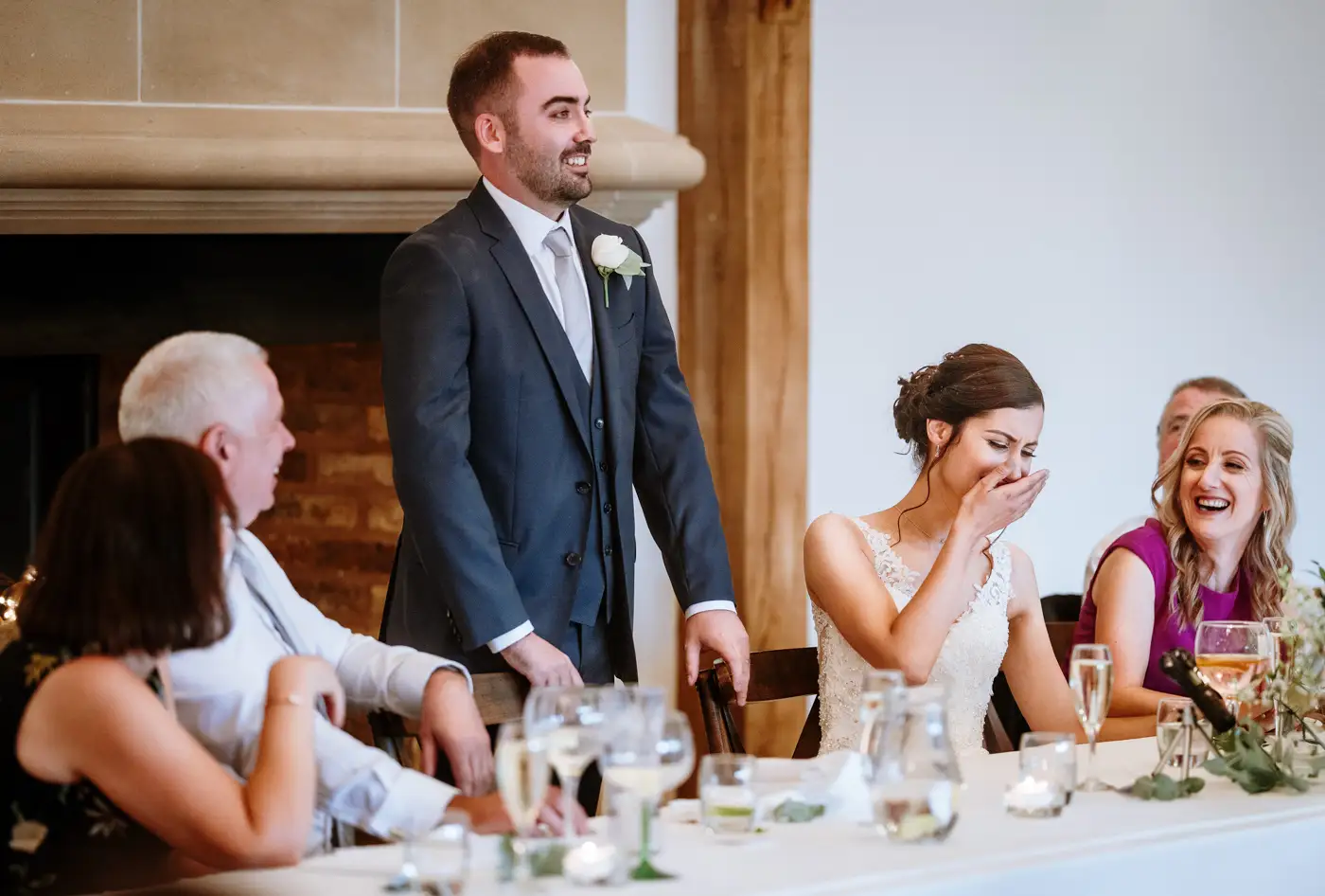Bride Krissie laughing at the groom's speech during the wedding breakfast at Swancar Farm, Nottinghamshire, candid documentary photography by Gary Phillip
