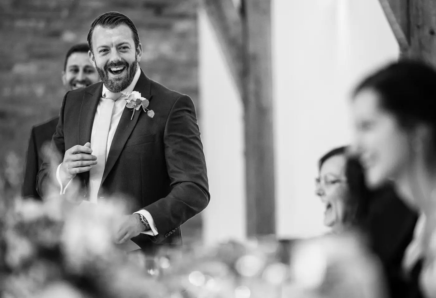 Best man laughing during his wedding speech at Swancar Farm, Nottinghamshire, a joyful honest moment from the wedding breakfast photographed by Gary Phillip