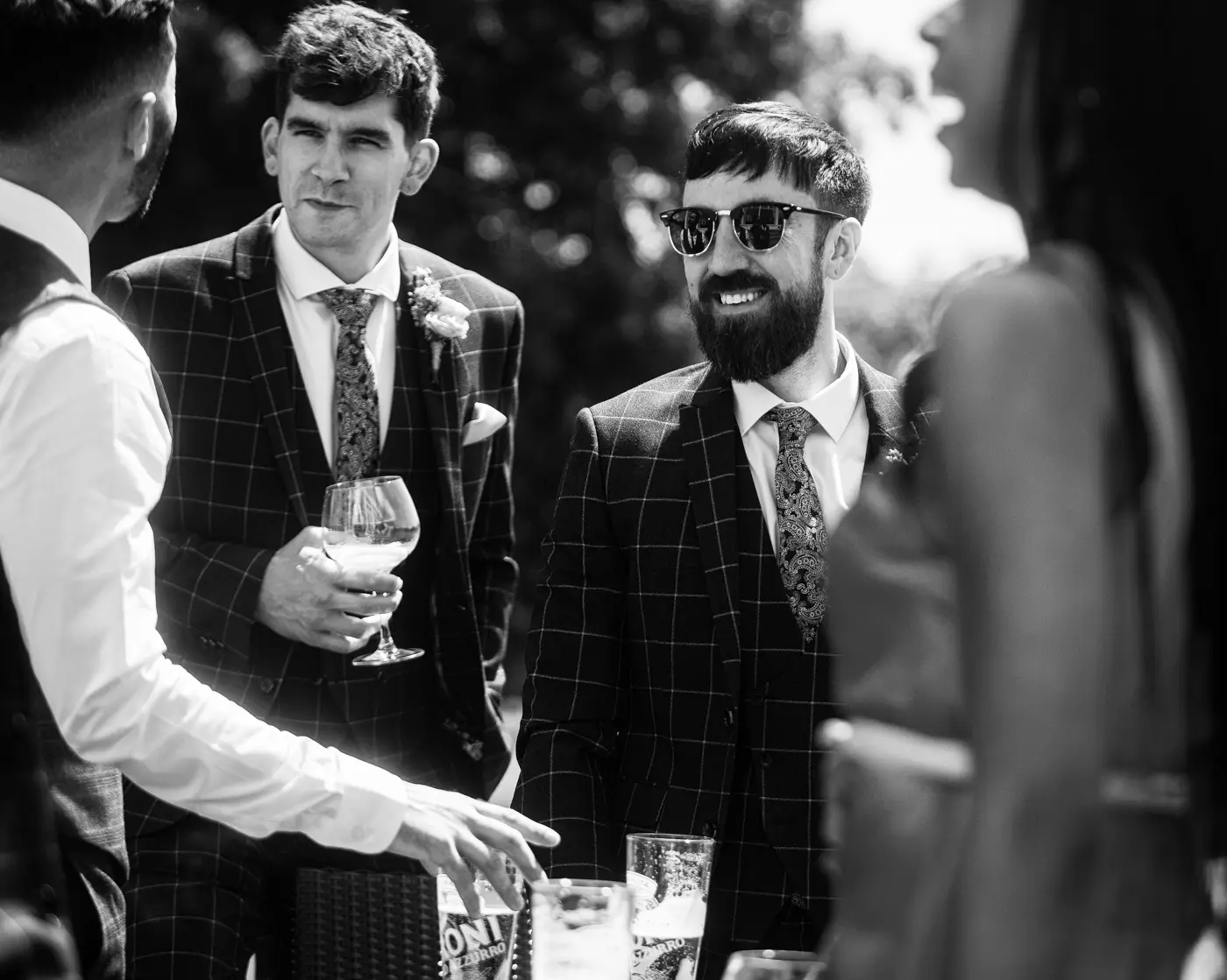 Black and white portrait of groom Gavin relaxed and chilling with his friends before the ceremony at Beeston Fields, Nottingham