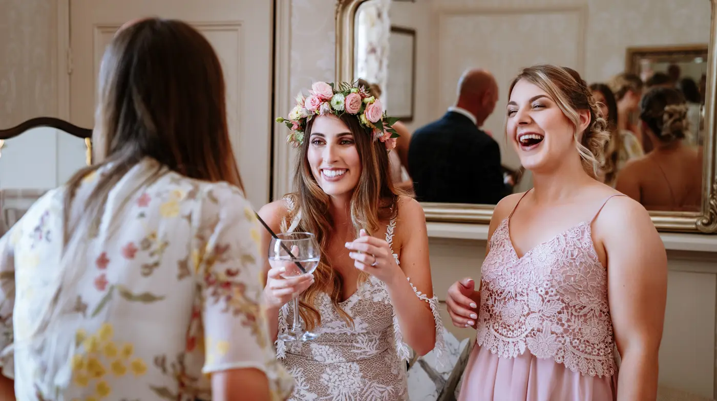 Bride Laura laughing with her bridesmaids during wedding morning preparations at Beeston Fields, Nottingham, candid documentary photography by Gary Phillip