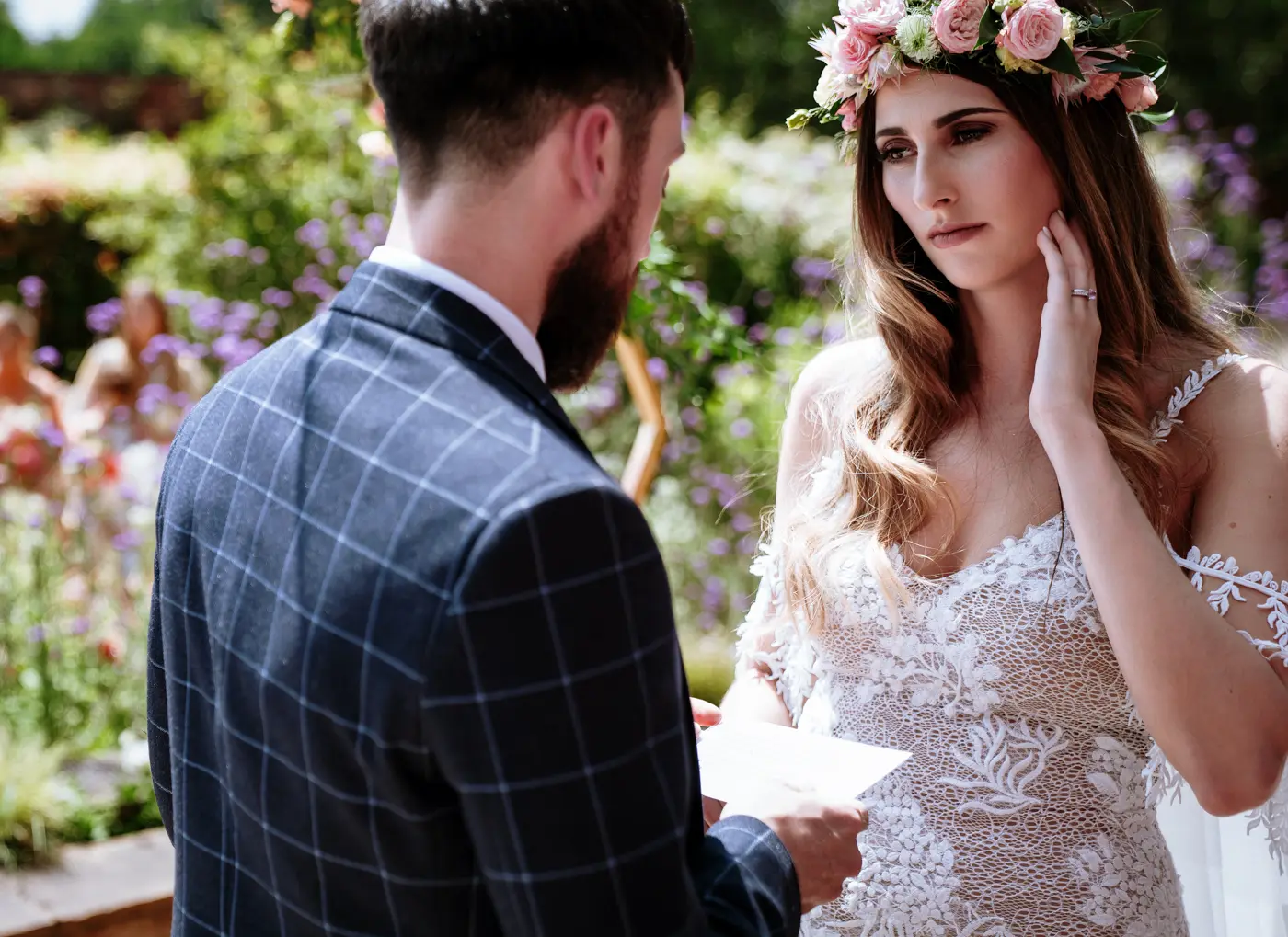 Groom Gavin reading his wedding vows while bride Laura listens intently during their ceremony at Beeston Fields, Nottingham