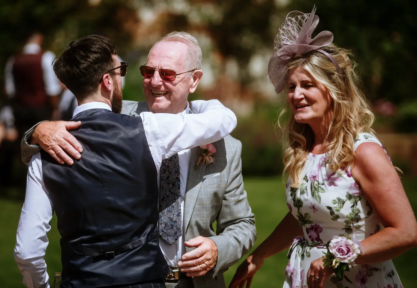 Groom Gavin hugging his grandad with a big smile on grandad's face at The Walled Garden at Beeston Fields, Nottingham