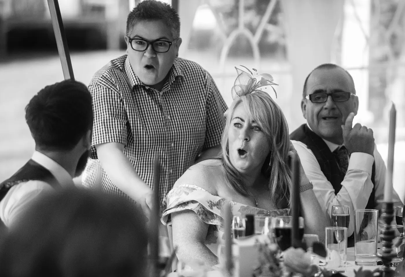Mother of the bride and her friend open-mouthed in shock at something groom Gavin has said during the speeches at Beeston Fields, Nottingham