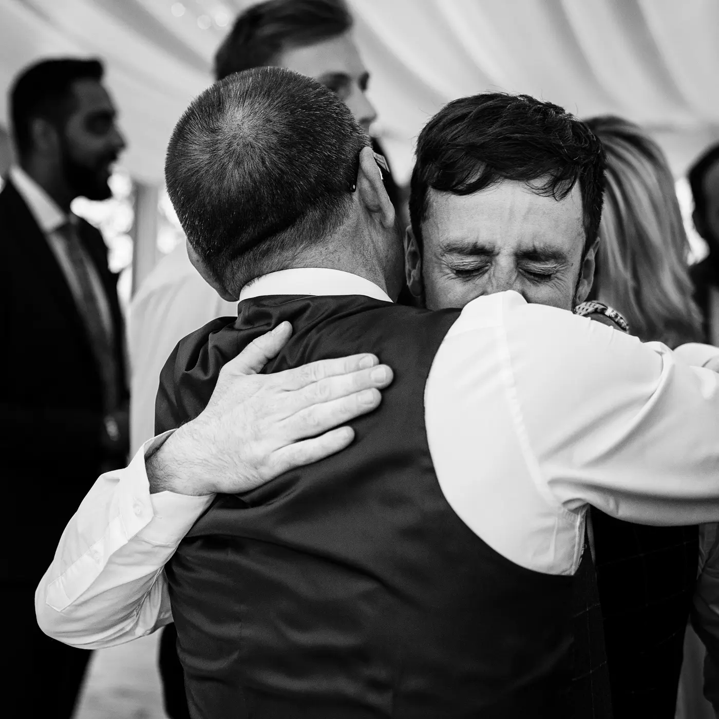Groom Gavin becoming emotional while hugging his father during the wedding reception at Beeston Fields, Nottingham, a genuine tender moment by Gary Phillip