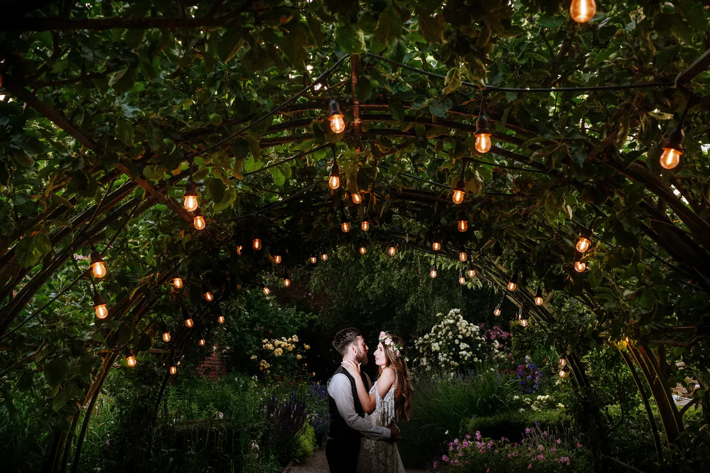 Portrait of bride Laura and groom Gavin under the arches at The Walled Garden at Beeston Fields, Nottingham, documentary wedding photography by Gary Phillip