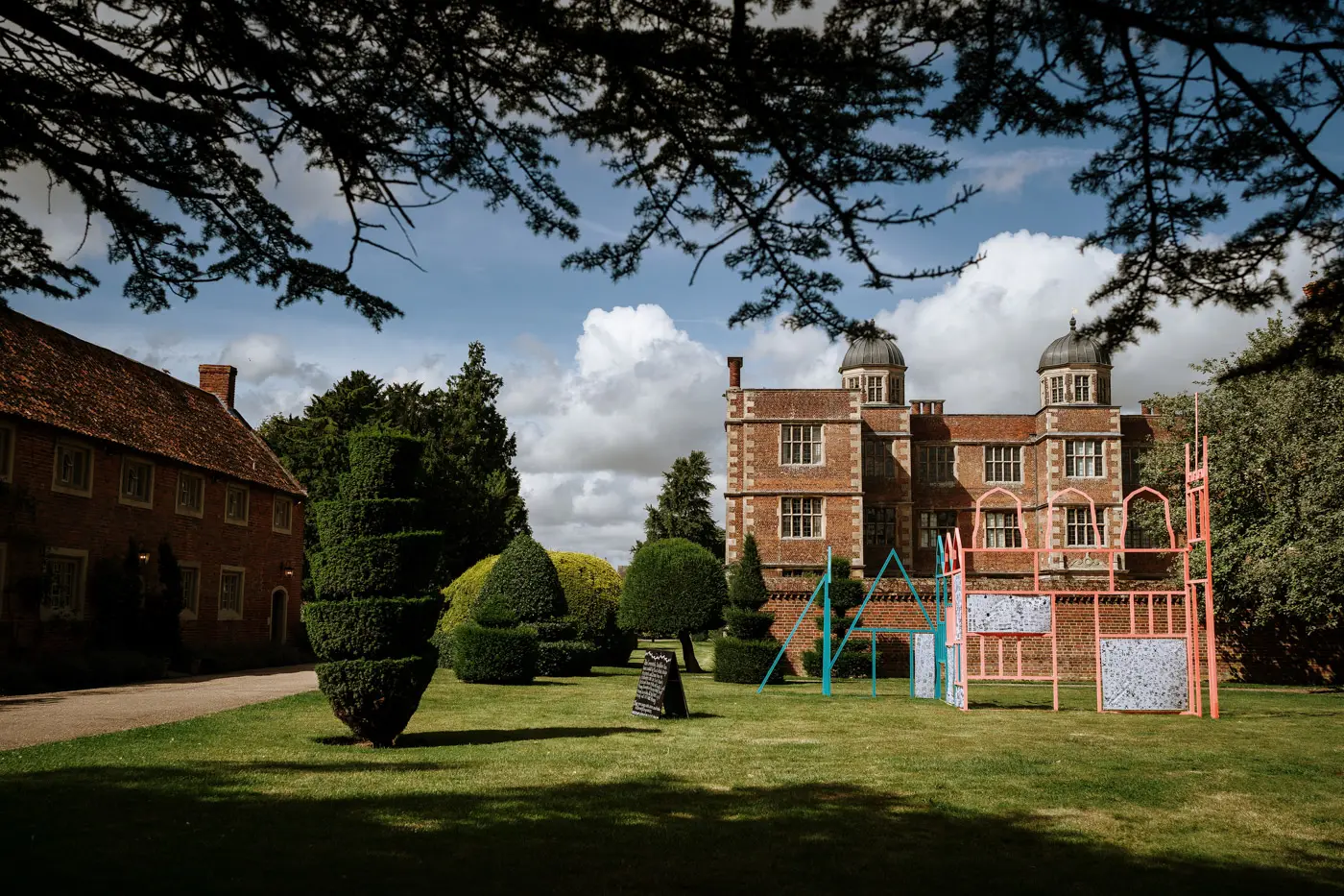 Doddington Hall in Lincolnshire seen from under a tree, one of the finest private country house wedding venues in the East Midlands