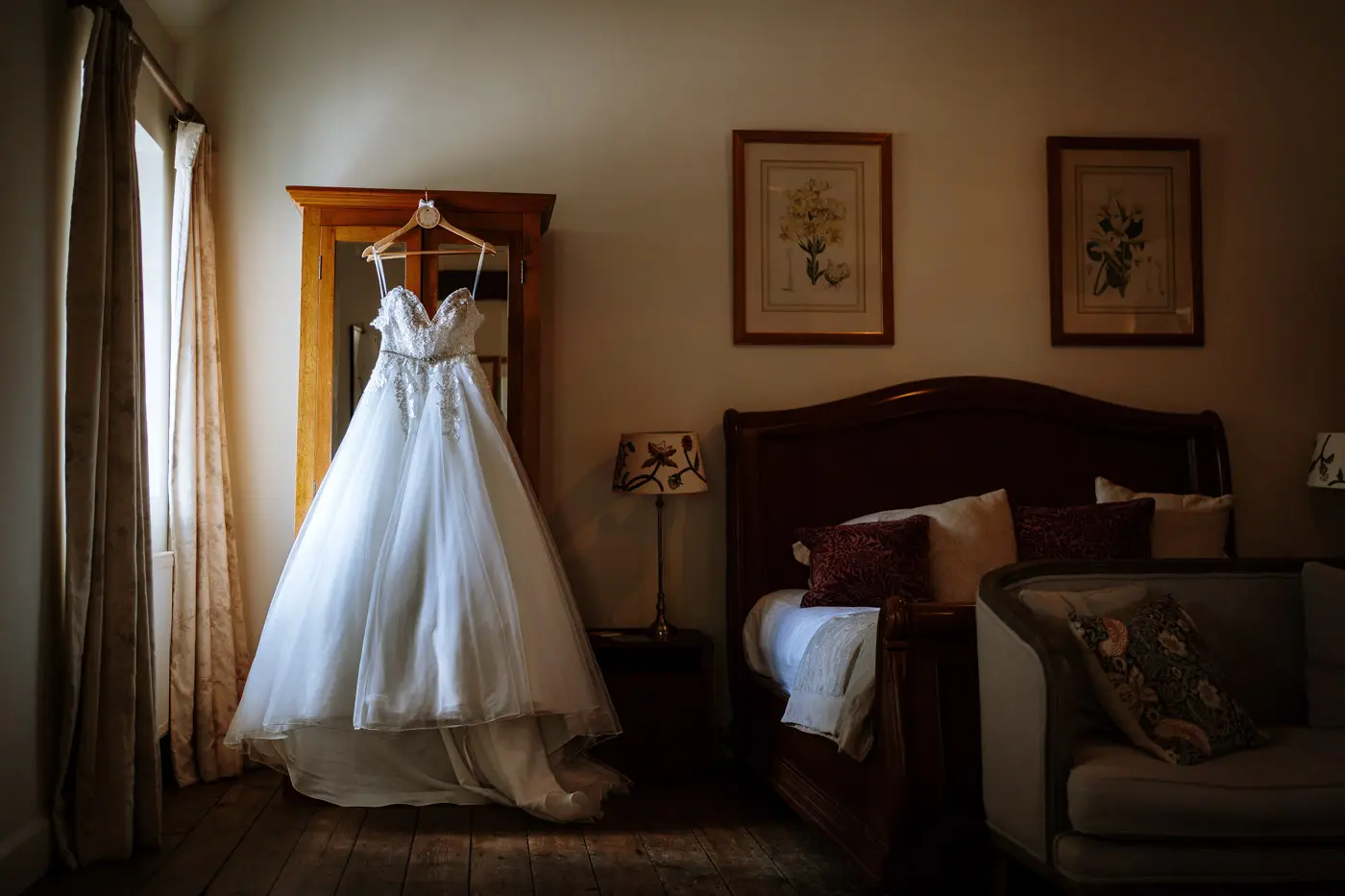 Louise's wedding dress hanging in the bridal suite at Doddington Hall, Lincolnshire on her wedding morning