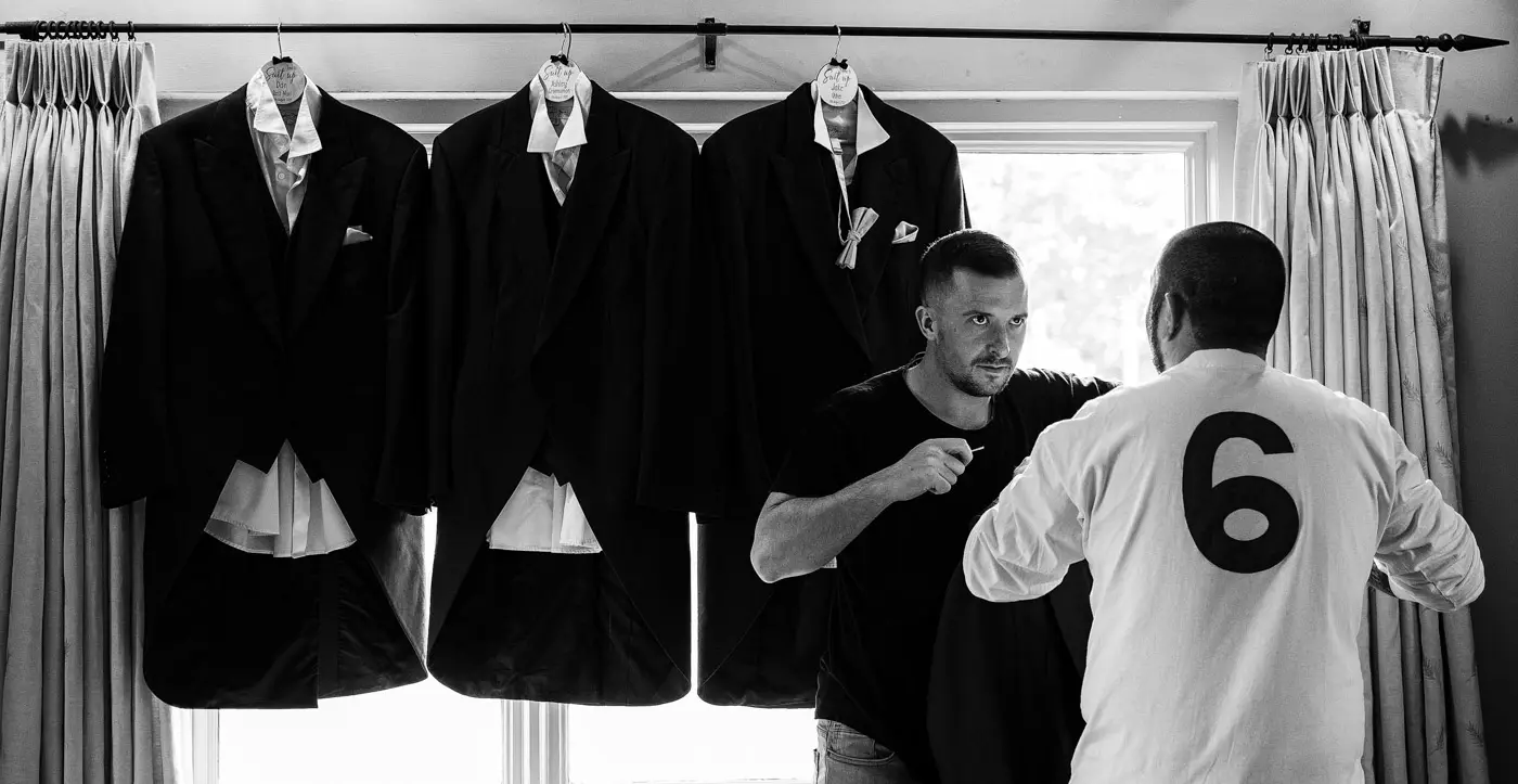 The groomsmen's suits hung in a window at Doddington Hall while the ushers get themselves organised on the wedding morning