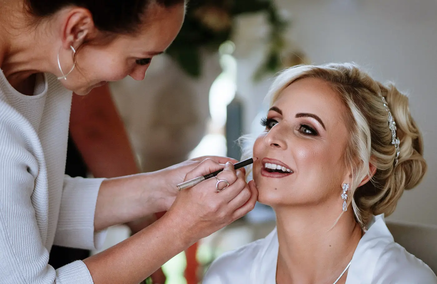 Bride Louise having her makeup applied on her wedding morning at Doddington Hall, Lincolnshire, documentary wedding photography by Gary Phillip