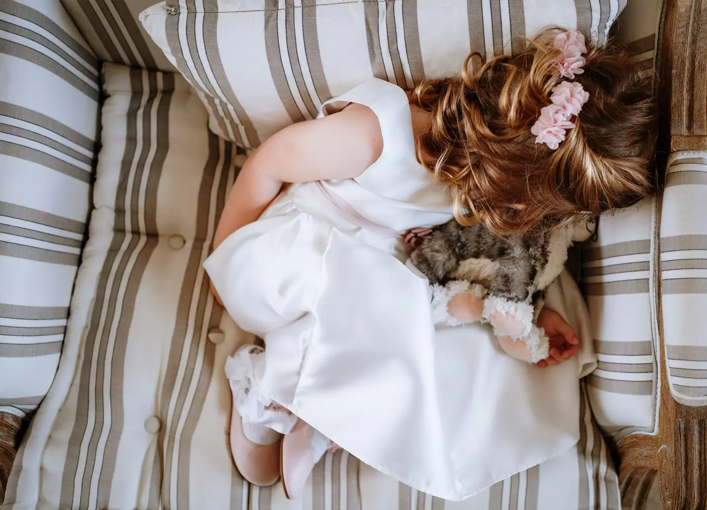 The flower girl asleep ahead of the wedding ceremony at Doddington Hall, a quiet honest moment captured by Gary Phillip