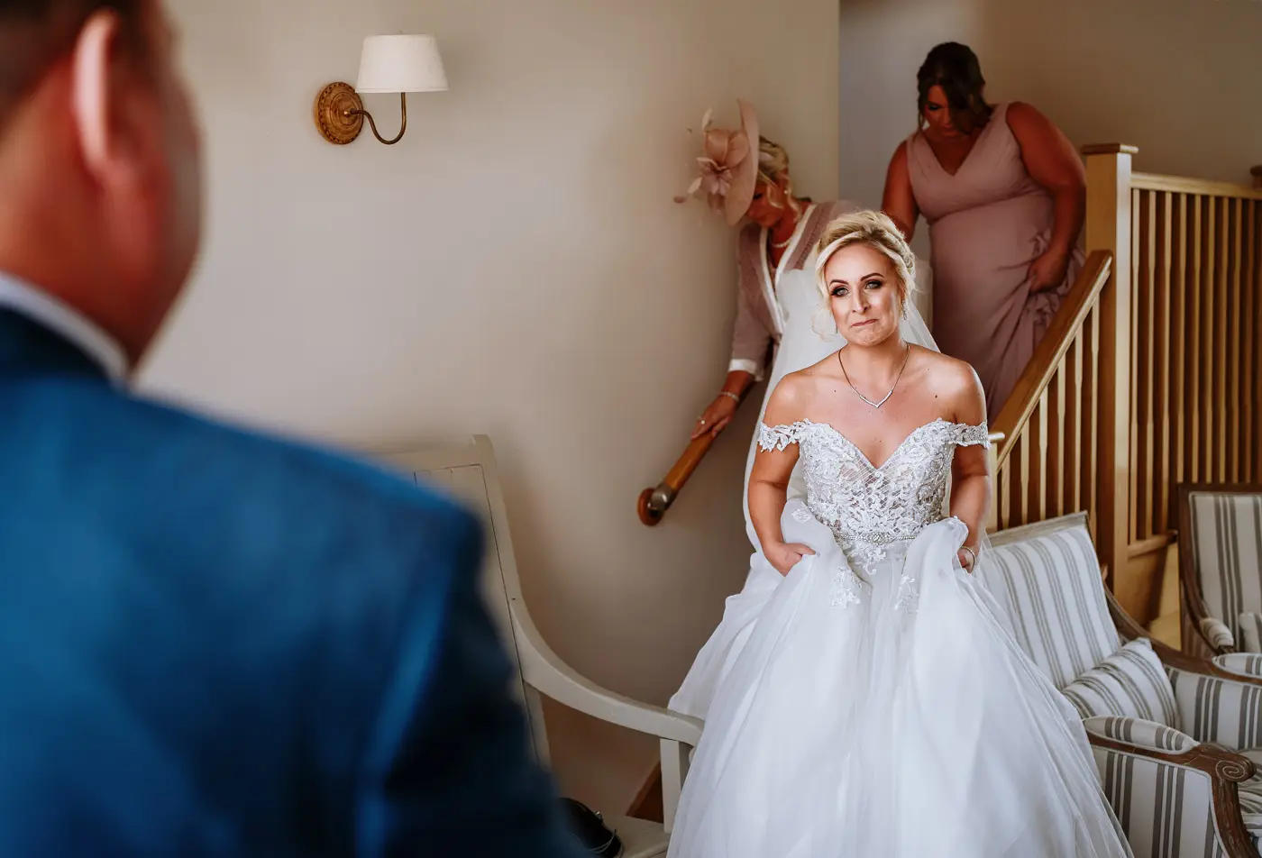 Bride Louise becoming emotional during her first look with her father on her wedding morning at Doddington Hall, Lincolnshire