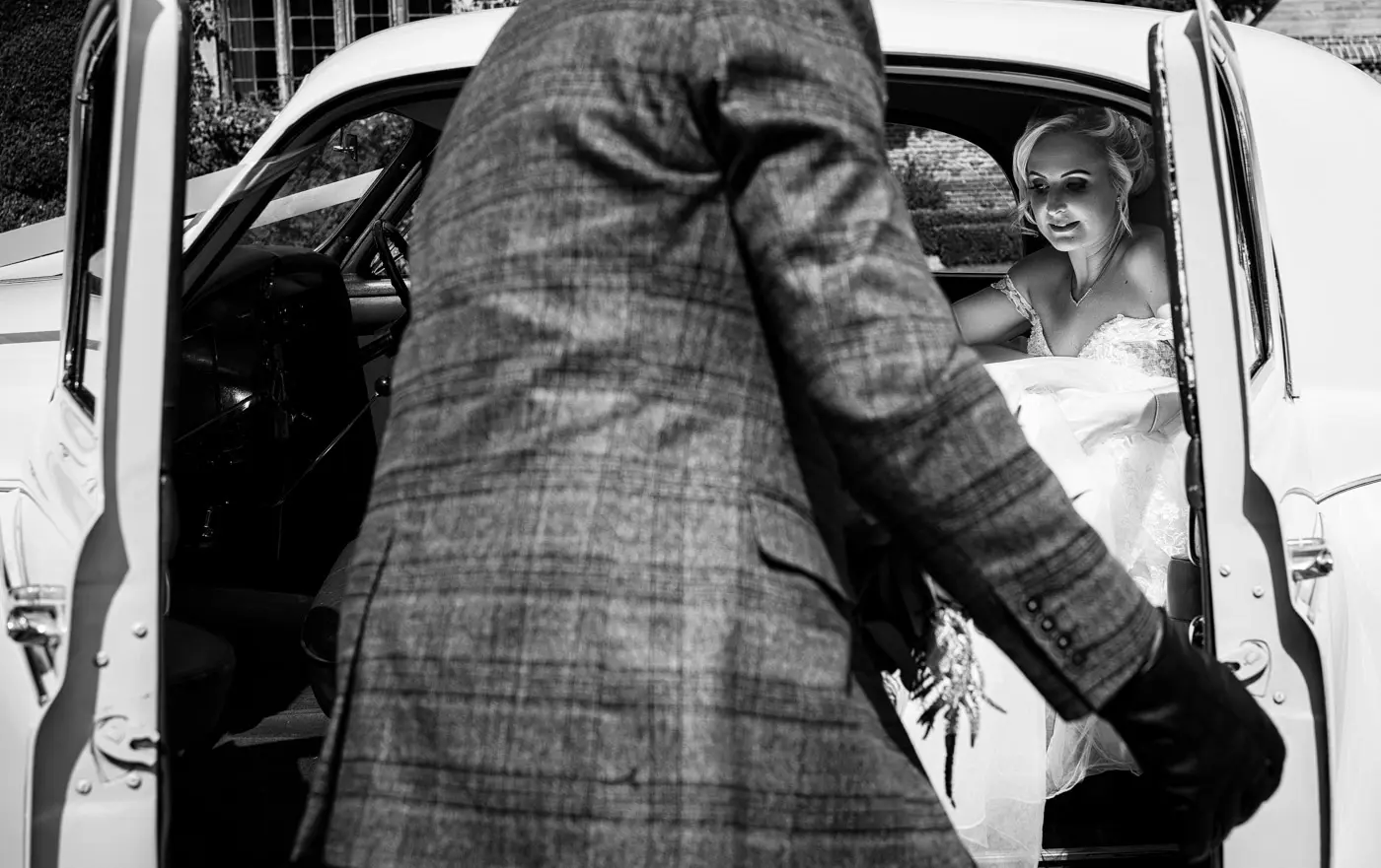 Bride Louise about to emerge from the wedding car outside Doddington Hall, Lincolnshire on her wedding day