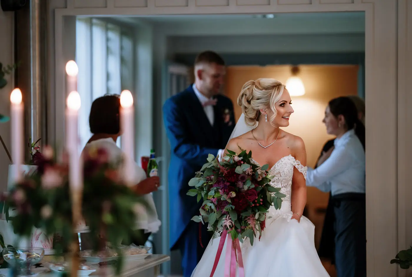 Bride Louise seeing the coach house wedding breakfast room at Doddington Hall for the first time, a genuine reaction captured by Gary Phillip