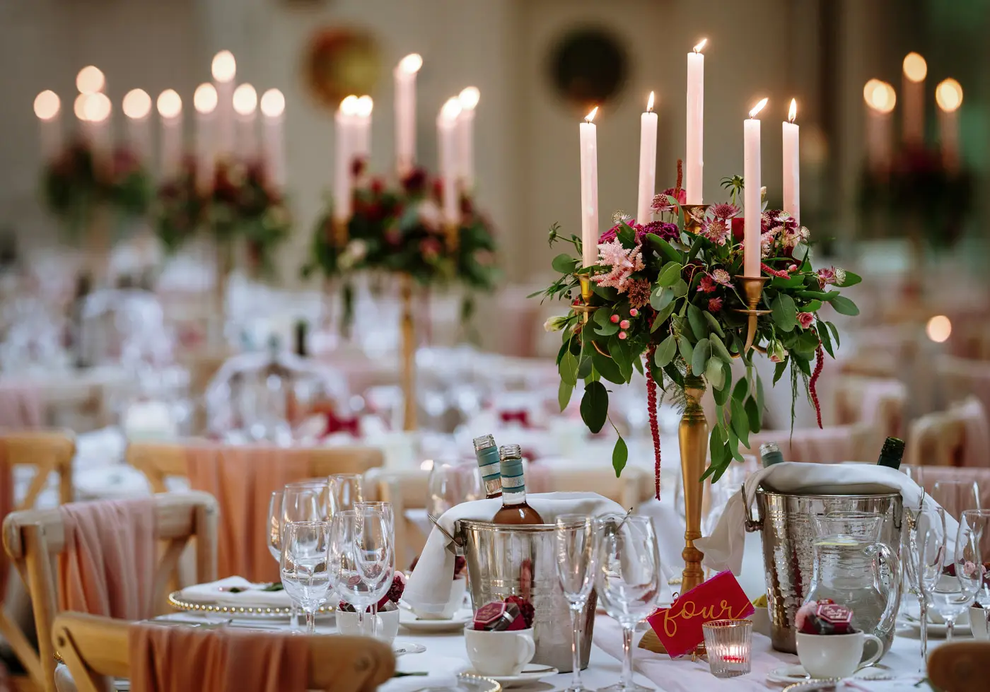 The coach house at Doddington Hall beautifully set with candles for Louise and Martin's wedding breakfast in Lincolnshire