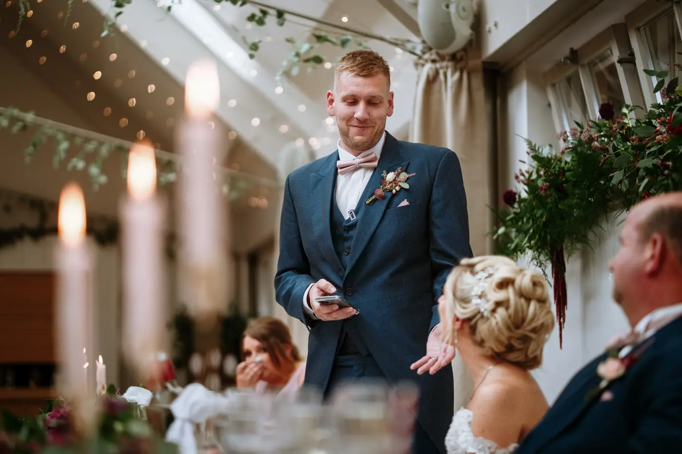 Groom Martin making his wedding speech at Doddington Hall unable to take his eyes off his bride Louise, Lincolnshire