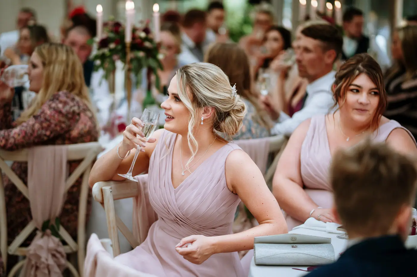 Guests enjoying the wedding speeches at Doddington Hall, Lincolnshire during Louise and Martin's wedding reception