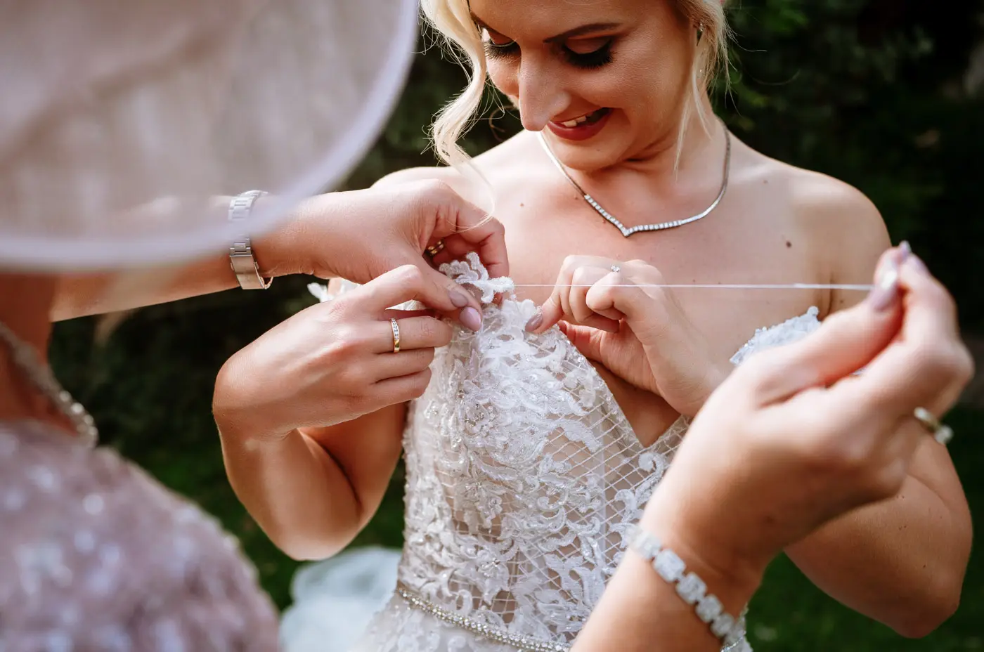 Mother of the bride stitching bride Louise's wedding dress back together after it fell apart at Doddington Hall, one of the most memorable moments of the day