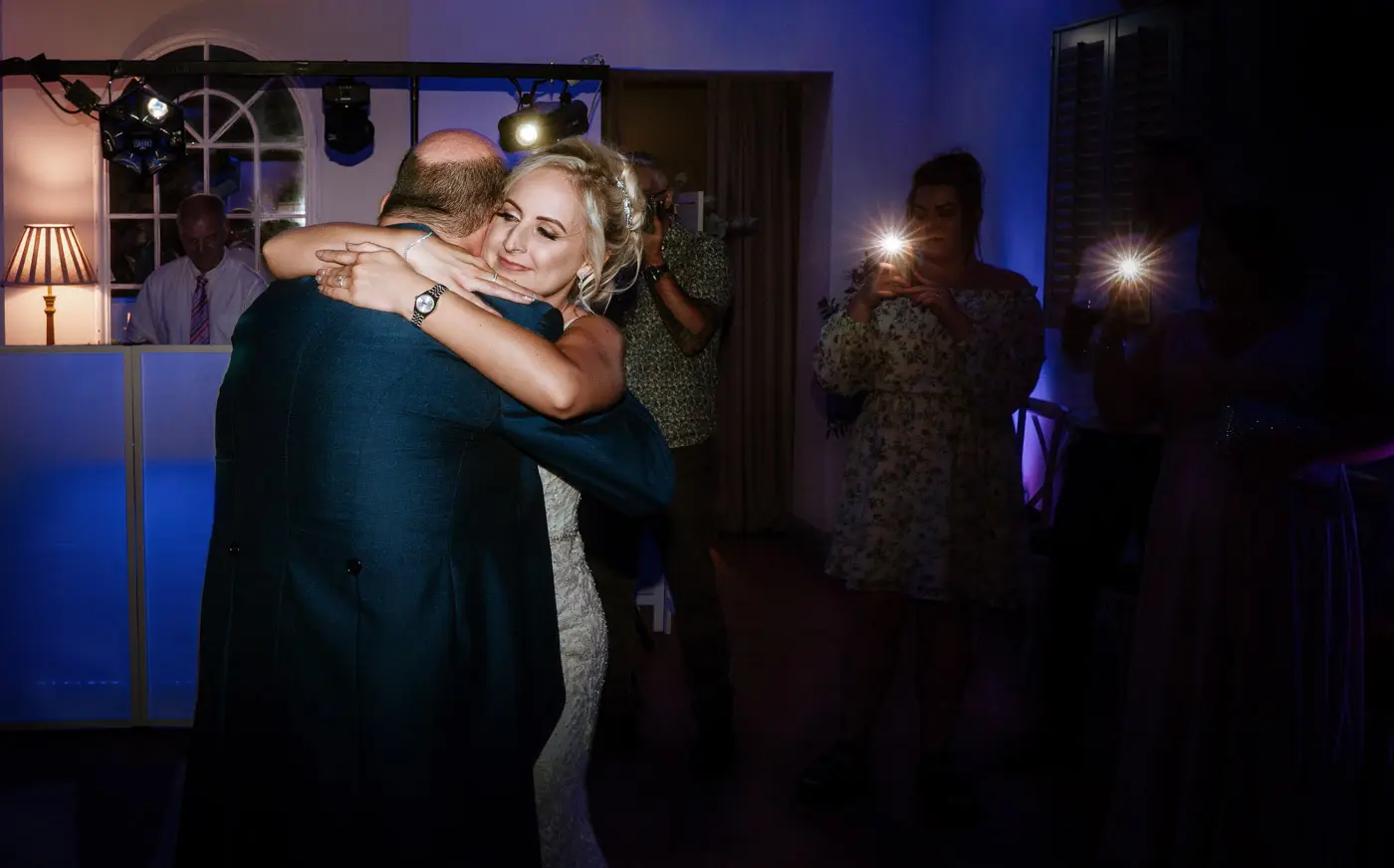 Bride Louise dancing with her father during the father daughter dance at Doddington Hall, Lincolnshire on her wedding evening