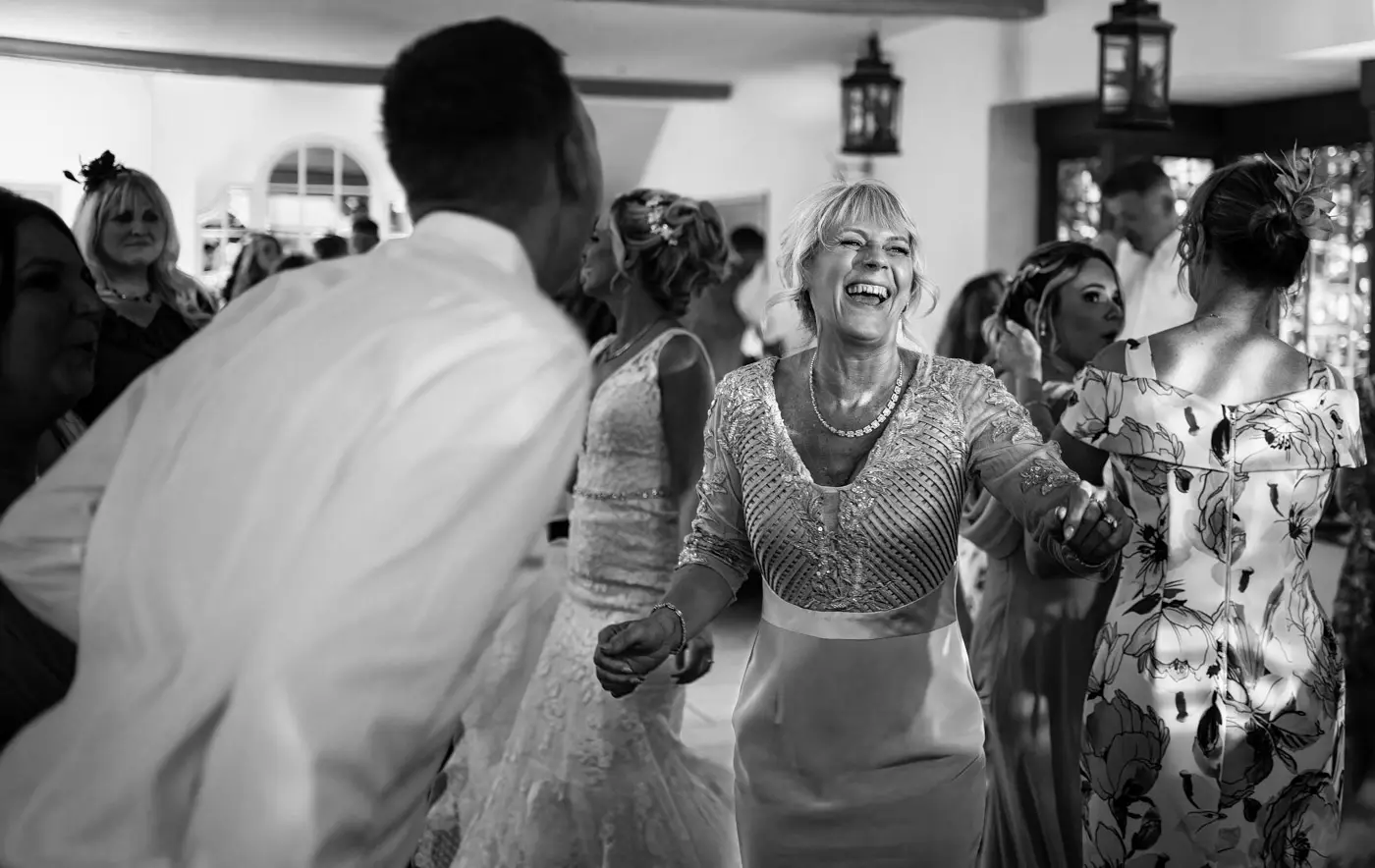 Mother of the bride absolutely loving the dancefloor at Doddington Hall, Lincolnshire on Louise and Martin's wedding evening
