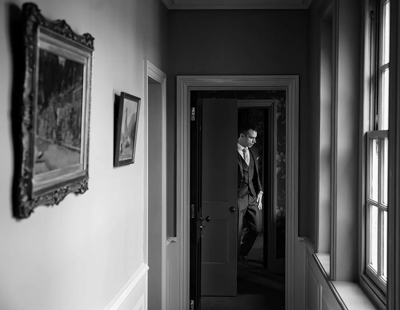 Groom Luke leaving his room at Stubton Hall heading directly to get married, a decisive candid moment by documentary wedding photographer Gary Phillip