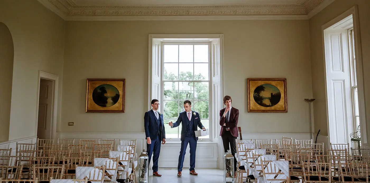 Groom Luke directing his groomsmen in the wedding room at Stubton Hall, Nottinghamshire before the ceremony, candid documentary photography by Gary Phillip