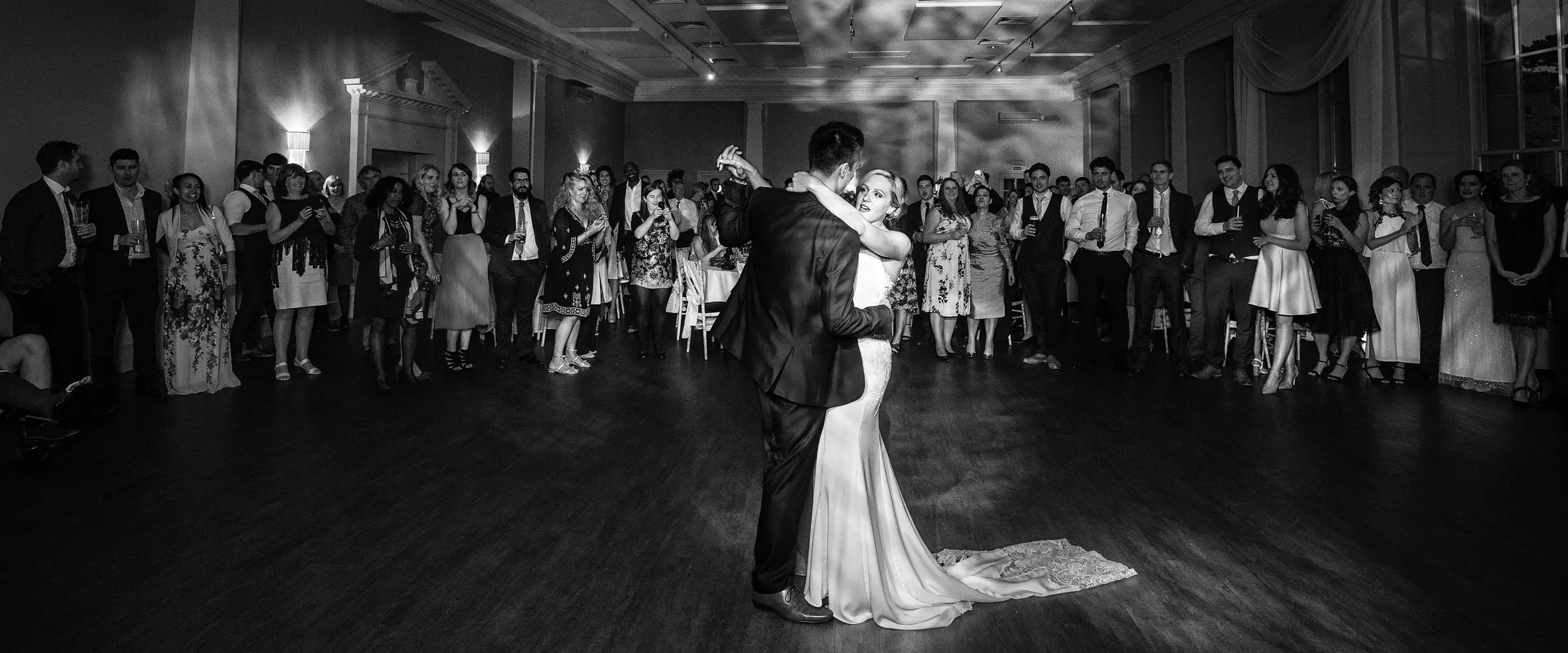 Sally and Luke first dance in black and white surrounded by family and friends at Stubton Hall, Nottinghamshire