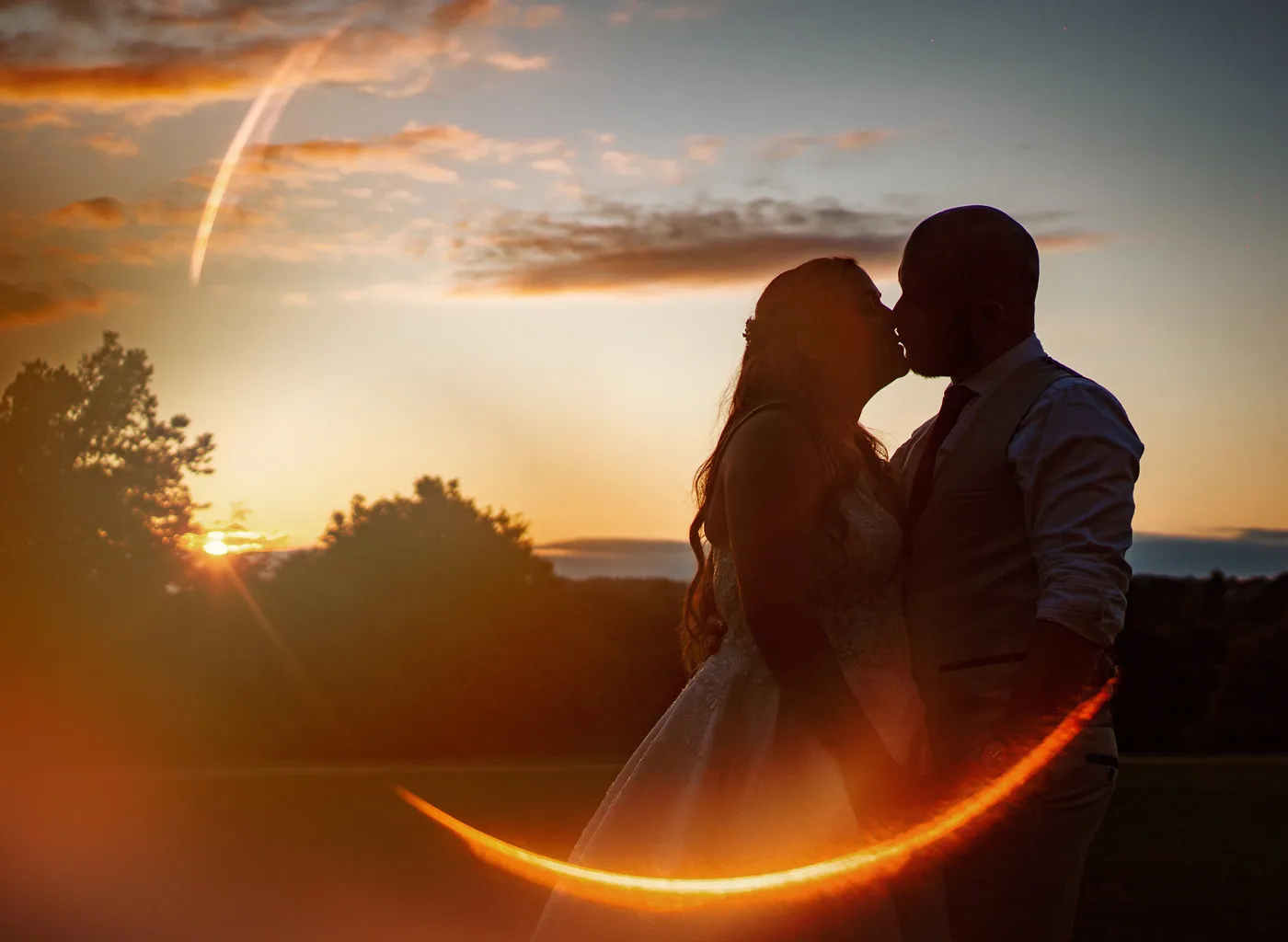 Amy and Andy silhouetted at sunset in the grounds of Wollaton Hall — wedding photography by Gary Phillip, Nottingham
